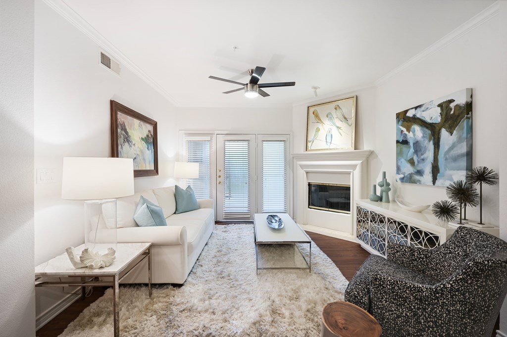 a living room with a white couch and a fireplace